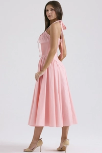 Detail of the back tie-up bow and halter neckline on a pink floral summer midi dress