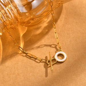 Gold-plated paperclip chain necklace with white enamel circle and OT toggle clasp