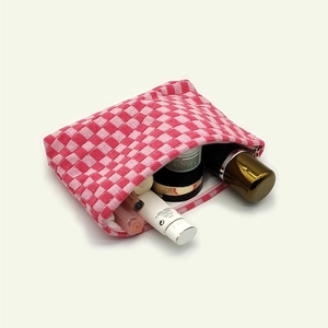 Pink and white checkered knit cosmetic bag with open zipper showing large capacity storage