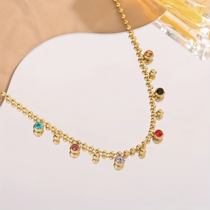 Detailed close-up of gold bead chain necklace with colorful crystal bezel pendants