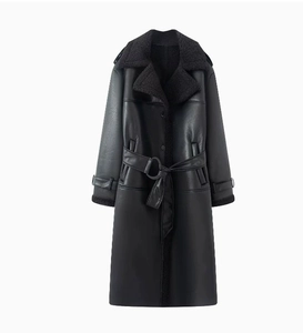 Detail of black faux shearling coat showing lapel texture and matching waist belt