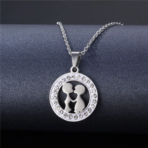 Romantic silver necklace featuring a sparkling round pendant with embracing couple silhouette