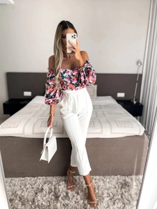 Floral off-shoulder puff sleeve top with white high-waist slim fit belted trousers