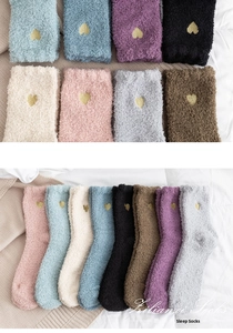 Detailed view of fluffy coral fleece sleep socks with gold heart embroidery in eight colors