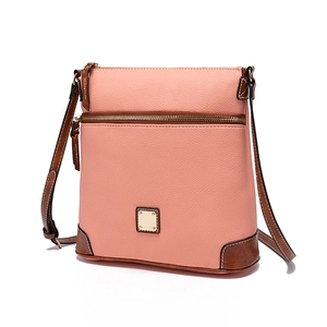 Detail of pink and brown pebble leather shoulder bag with gold hardware and front zipper