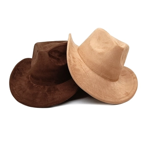 Detail of dark brown and tan wide brim suede hats stacked on white background