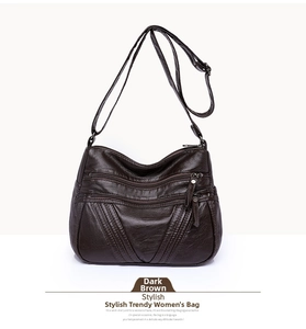 Detailed view of dark brown washed PU leather crossbody bag with multiple zip pockets