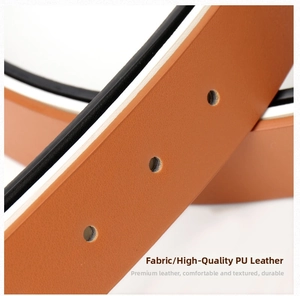 Detail of tan PU leather belt featuring precise round holes and refined embossed texture