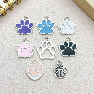 Flat lay of colorful DIY animal paw charms in various pastel oil-dripping alloy styles