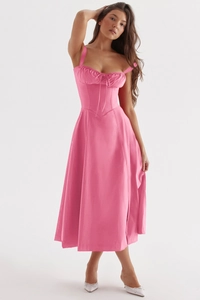 Detail of a pink satin corset midi dress featuring slim straps and a flowing A-line skirt