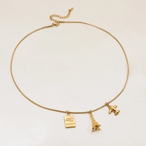 Detail of 18K gold stainless steel necklace with passport, tower and plane pendants