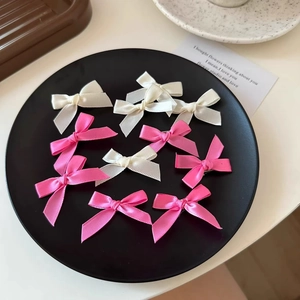 Pink and white 4cm ribbon bow hair clips set on a black tray with sweet ballet style