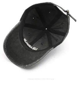 Detail of washed grey baseball cap interior showing metal buckle and reinforced stitching