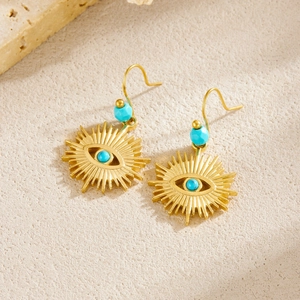 Bohemian gold evil eye stud earrings with turquoise beads on a natural stone base