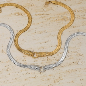 Macro detail of 316 stainless steel snake head necklaces in gold and silver finish