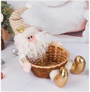 Detail of a festive Santa Claus doll with a sequined hat holding a woven candy basket