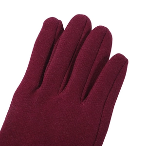 Close-up of the burgundy knit fabric and fine stitching on thermal winter gloves