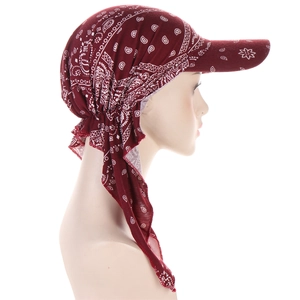 Detail of wine red paisley headscarf cap with brim and long side ribbons on mannequin
