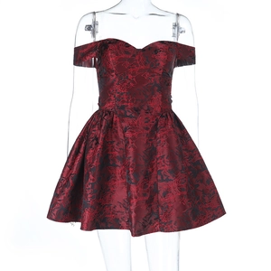 Detail of red and black floral jacquard fabric on an off-shoulder mini dress