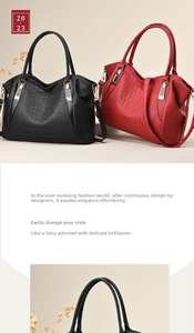 Detail of crocodile embossed leather tote bag showing red and black textures and gold hardware