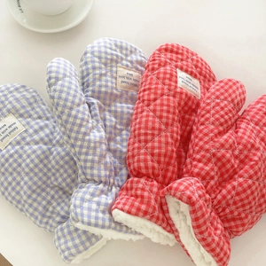 Detailed view of quilted cotton gloves with plush faux sheepskin lining and plaid pattern