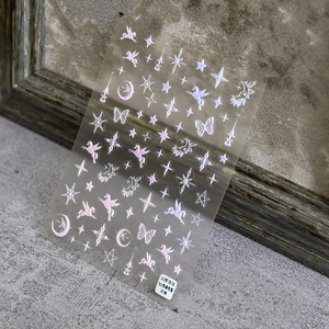 Detail of 5D embossed nail stickers featuring white and purple unicorns and stars