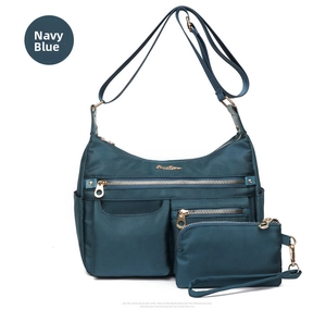 Detail of navy blue water-resistant nylon shoulder bag set with gold-tone hardware details