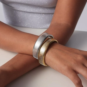Elegant gold and silver titanium steel snake chain bracelets worn by model for fashion