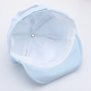 Detailed interior of infant cotton hat featuring white lining and soft brim stitching