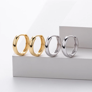 Macro shot of 925 sterling silver hoop earrings in gold and silver with 925 hallmark