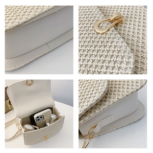 Detail view of woven straw crossbody bag showing gold lock, lining and internal storage