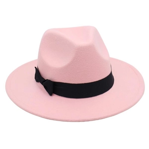 Close-up of pink wool fedora hat with elegant black ribbon bow and textured finish