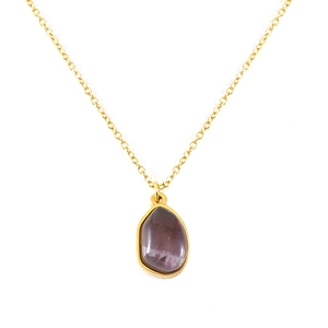 Minimalist gold necklace featuring a natural irregular purple gemstone pendant on white background