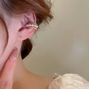 Three-layer gold-plated ear cuff with pearls, rhinestones, and hanging heart pendant