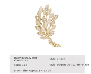 Detail of a golden wheat-shaped brooch with cream stones and sparkling rhinestones
