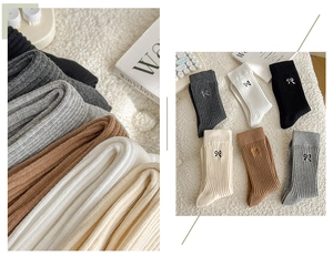 Detailed macro view of cotton ribbed socks with delicate bow embroidery decoration