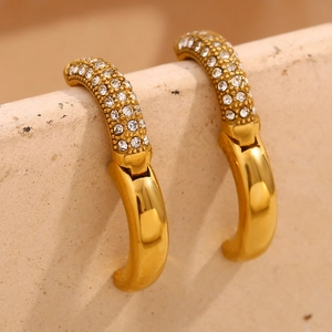 Macro shot of gold-plated 18K stainless steel hoop earrings with sparkling pavé zircons