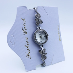 Detail of luxury silver quartz watch featuring hollow leaf strap with shimmering crystals