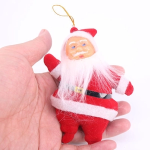 Close-up of a small plush Santa Claus ornament held in hand to show size and texture
