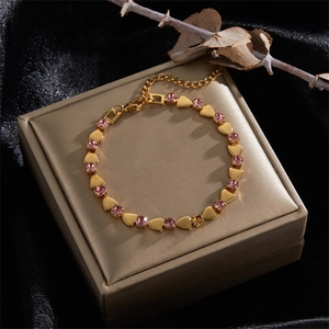 Elegant 18K gold plated heart bracelet with pink crystals on black silk background