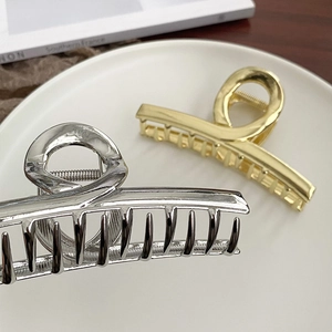 Large metal shark hair claw clips in gold and silver finish with minimalist hollow design