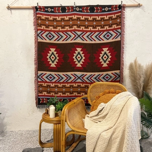 Bohemian woven camping blanket with colorful geometric patterns and decorative fringe