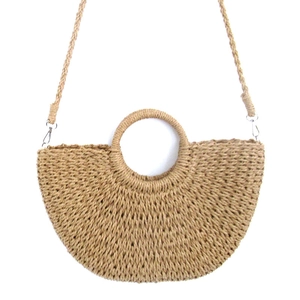 Handmade straw half-moon crossbody bag with round handle and woven strap for beach vacation