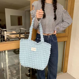 Close-up of light blue bubble textured tote bag with LOVE SOZAKKA woven label patch