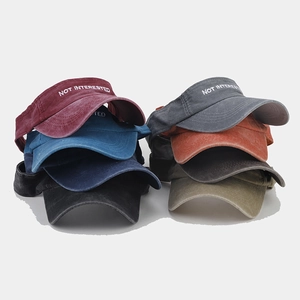 Detail showing various colors of washed cotton visors with embroidered text