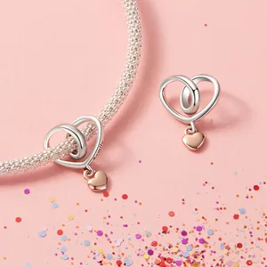 925 sterling silver heart charm bracelet with rose gold family pendant on pink background