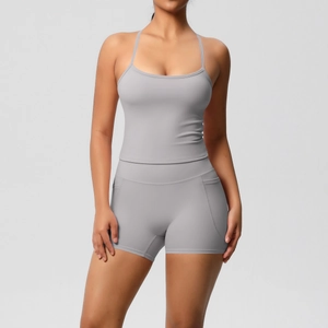 Detail of high-waist grey yoga shorts with side pocket and matching racerback tank top