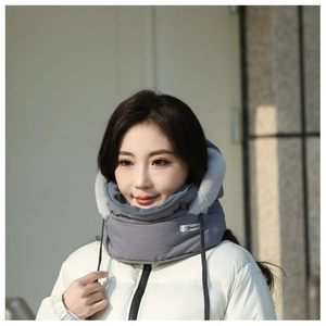 Detail of gray winter trapper hat with white faux fur lining and windproof drawstring hood
