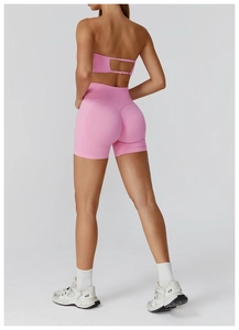 Rear view of pink seamless yoga set featuring cutout back bra and ruched lifting shorts