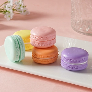 Set of five colorful macaron dessert models on a pink table for photography props